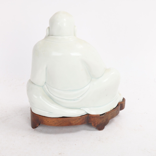 365 - A Chinese blanc de chine porcelain figure of Budai, on original fitted wood stand, height 14.5cm