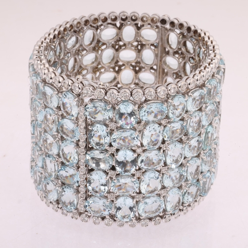 1112 - A fine 18ct white gold aquamarine and diamond hinged cuff bangle, set throughout with oval-cut aquam... 