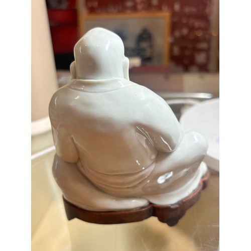 365 - A Chinese blanc de chine porcelain figure of Budai, on original fitted wood stand, height 14.5cm