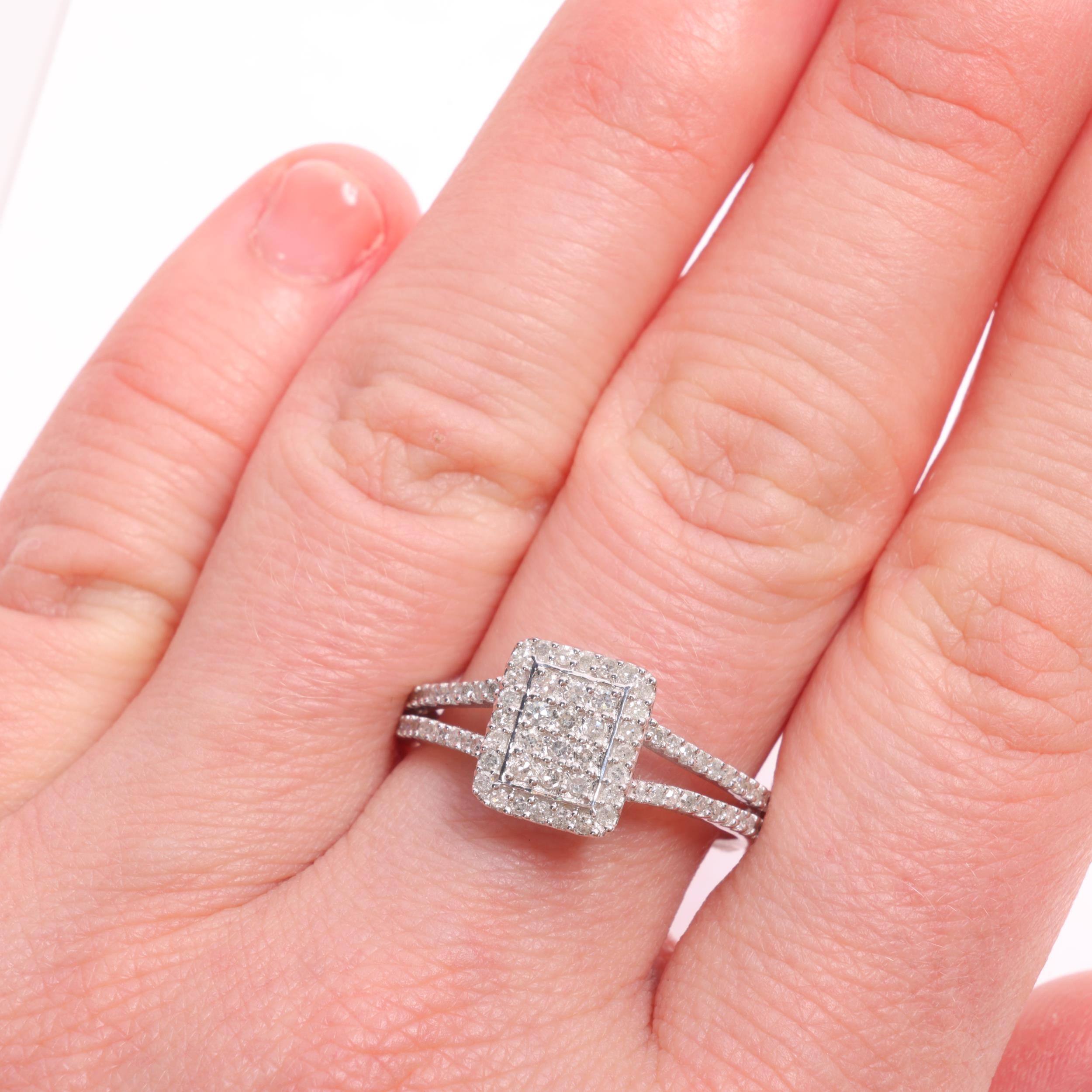 A 9ct white gold diamond cluster panel ring, by TJC, pave set with ...