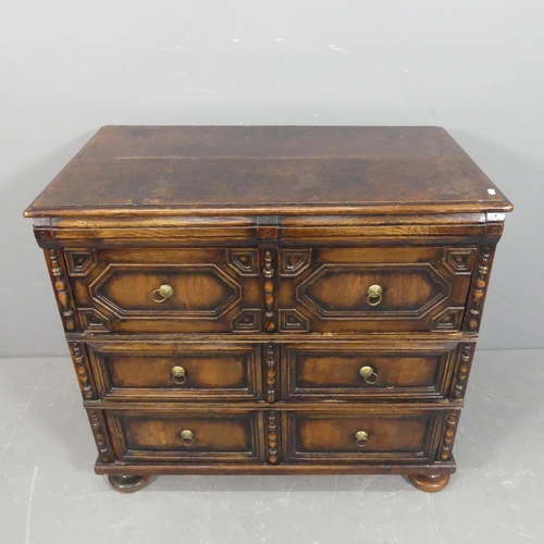 An antique Jacobean style oak chest of three long drawer, with carved ...