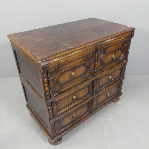 An antique Jacobean style oak chest of three long drawer, with carved ...