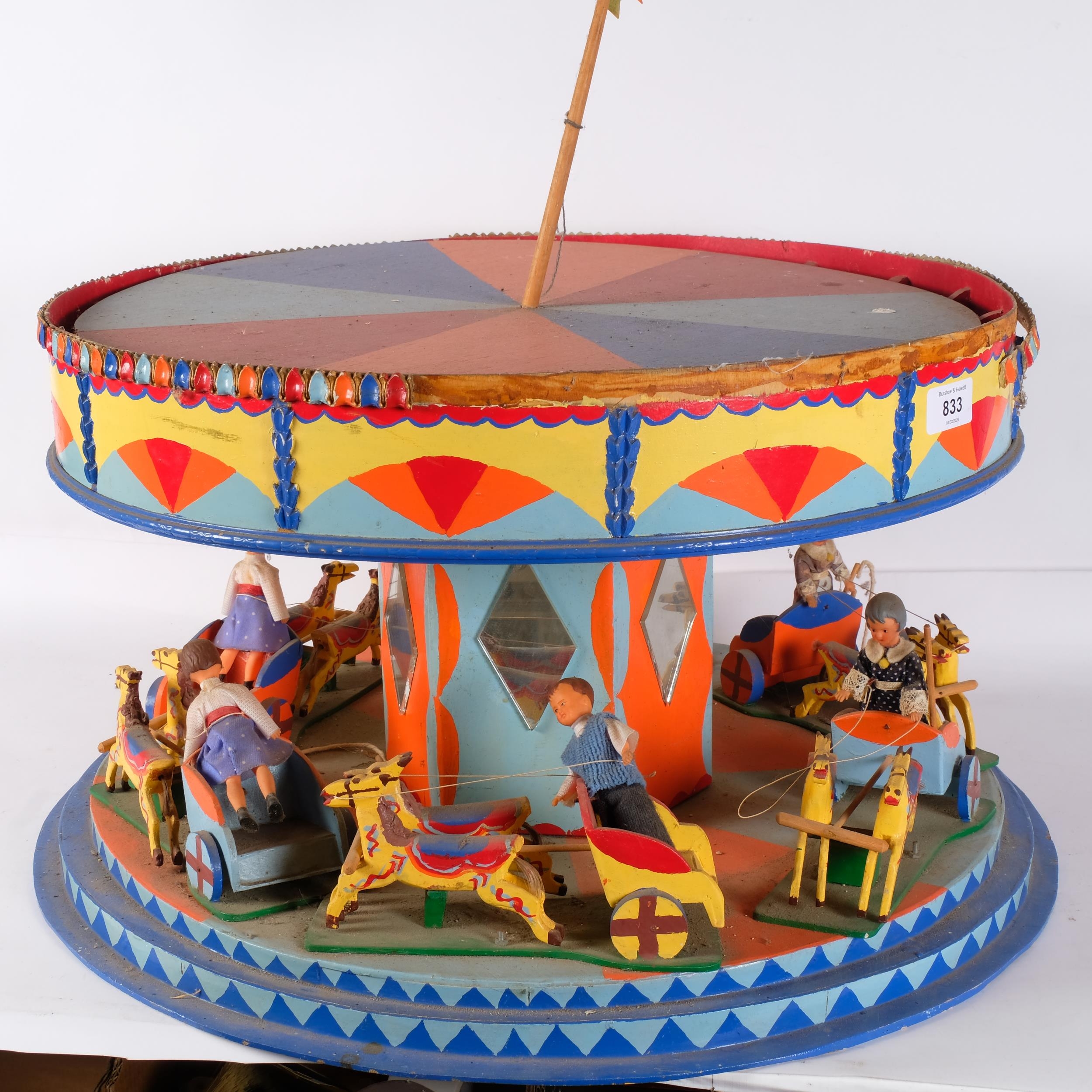 A Vintage scratch-built and hand painted carousel, diameter 51cm