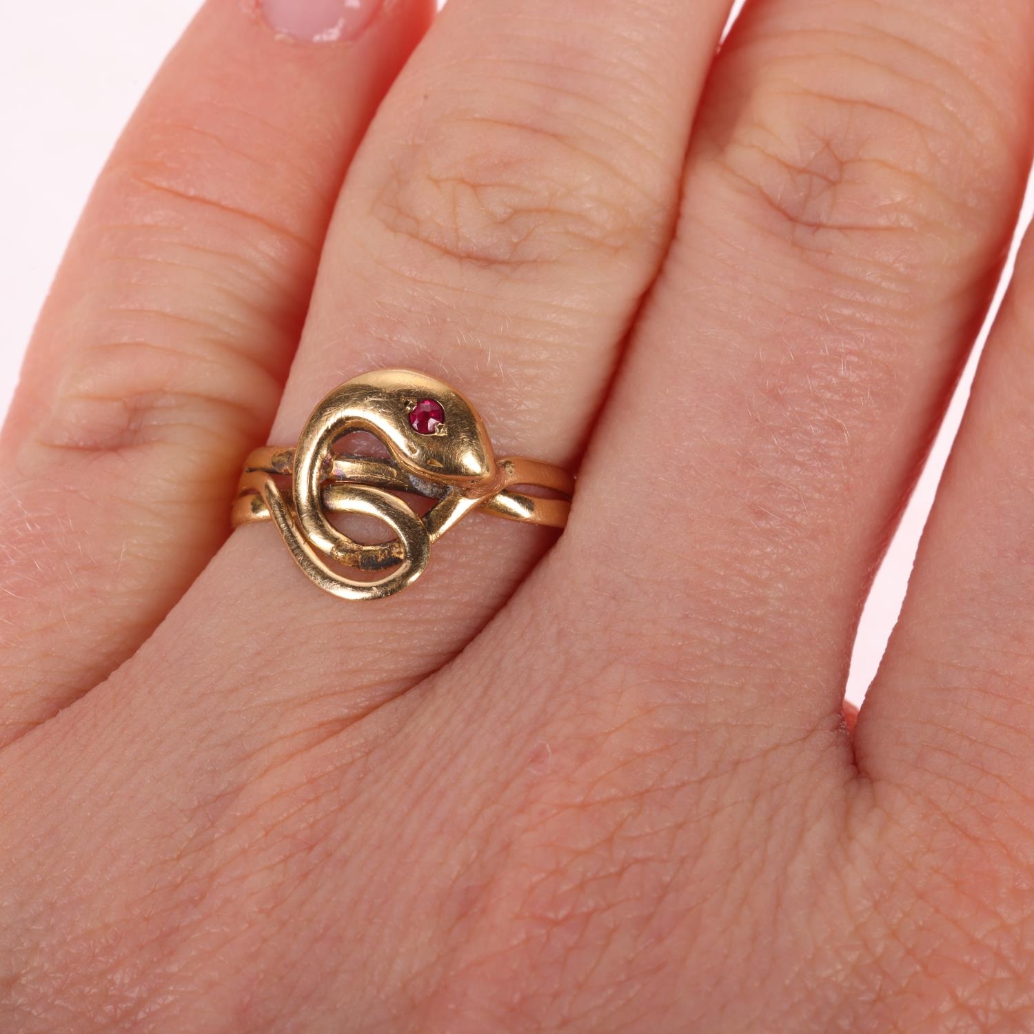An Antique French 18ct gold ruby snake ring, circa 1900, modelled as a ...