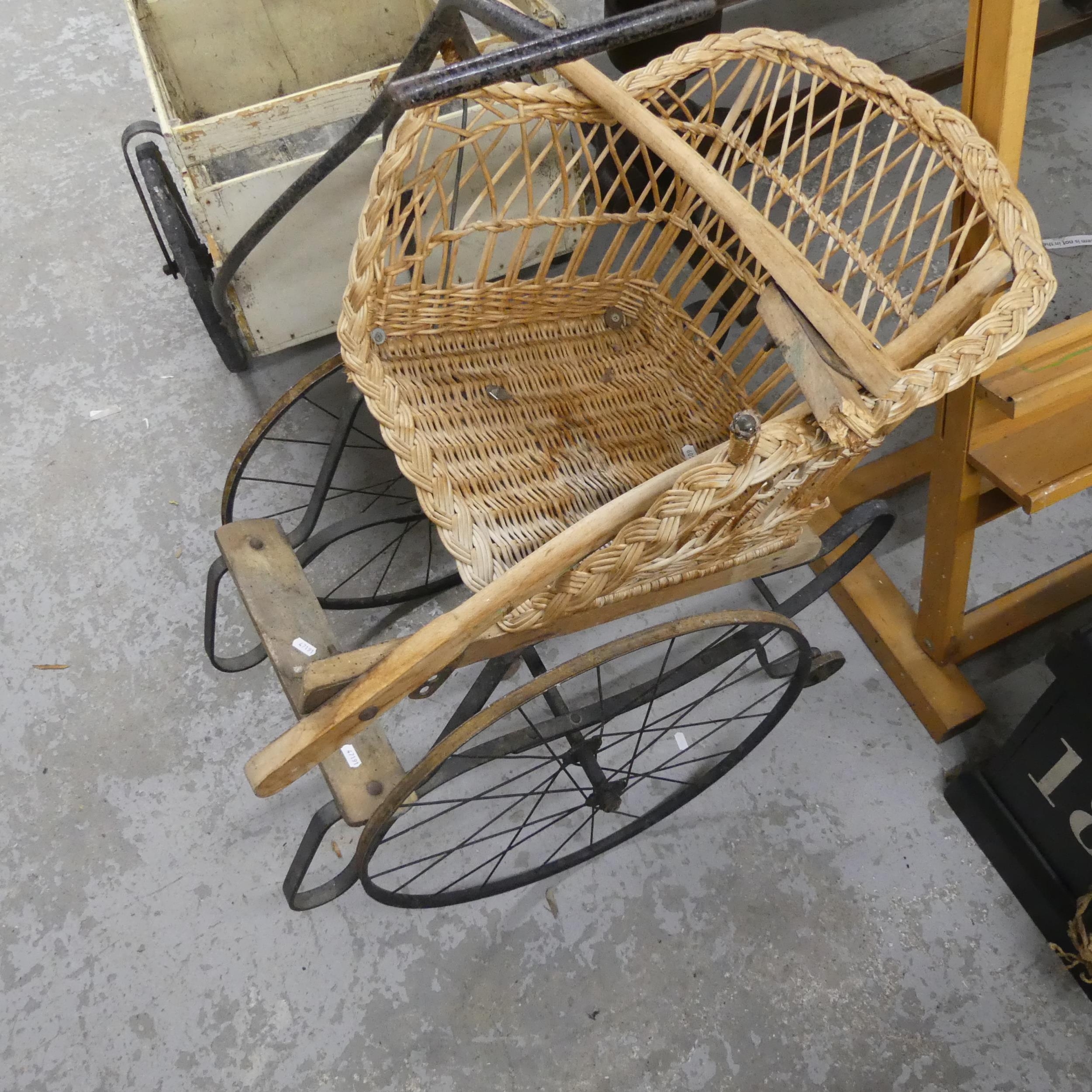 A vintage French Rickshaw / hand cart, with wicker seat and metal frame ...