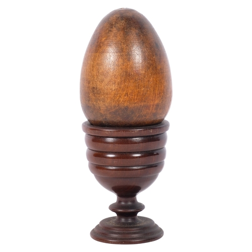 269 - An Antique treen egg cup, and younger carved wooden egg, cup H7cm