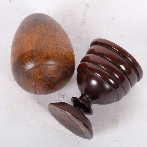 269 - An Antique treen egg cup, and younger carved wooden egg, cup H7cm