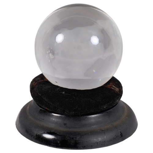 279 - A small fortune teller's crystal ball, on associated stand