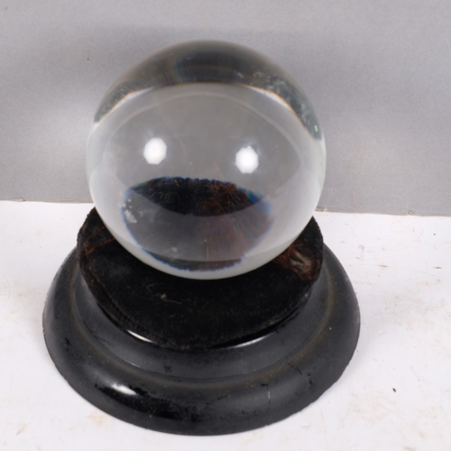 279 - A small fortune teller's crystal ball, on associated stand