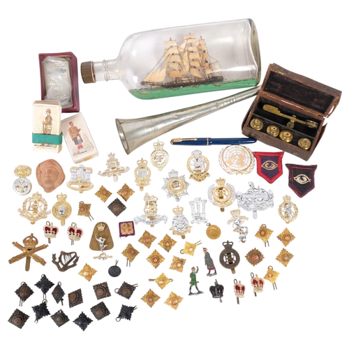 280 - MILITARY INTEREST - a collection of interesting militaria, including cap badges, cigarette cards, a ... 