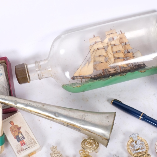 280 - MILITARY INTEREST - a collection of interesting militaria, including cap badges, cigarette cards, a ... 