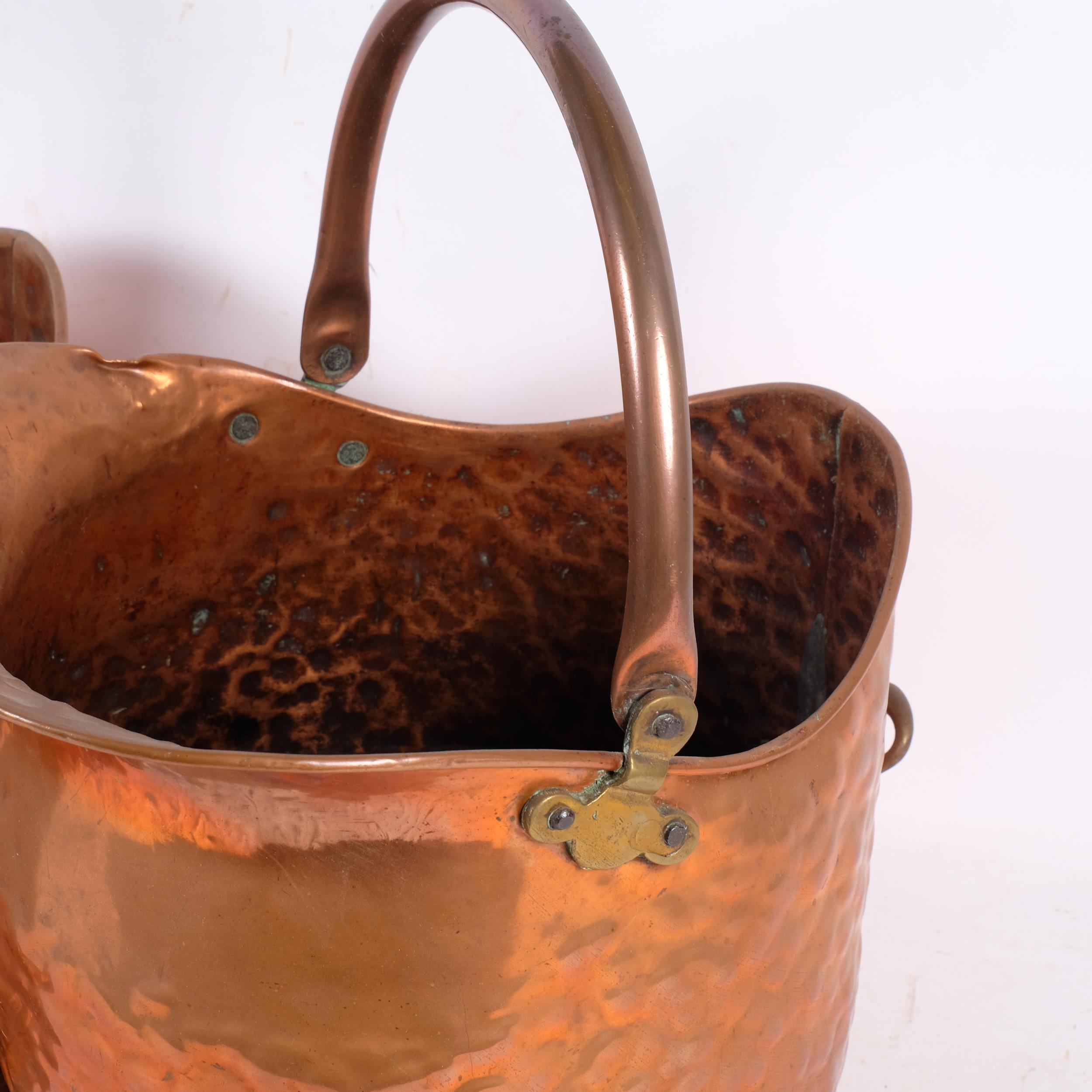 A pair of 19th century copper hand beaten coal scuttles, each with ...