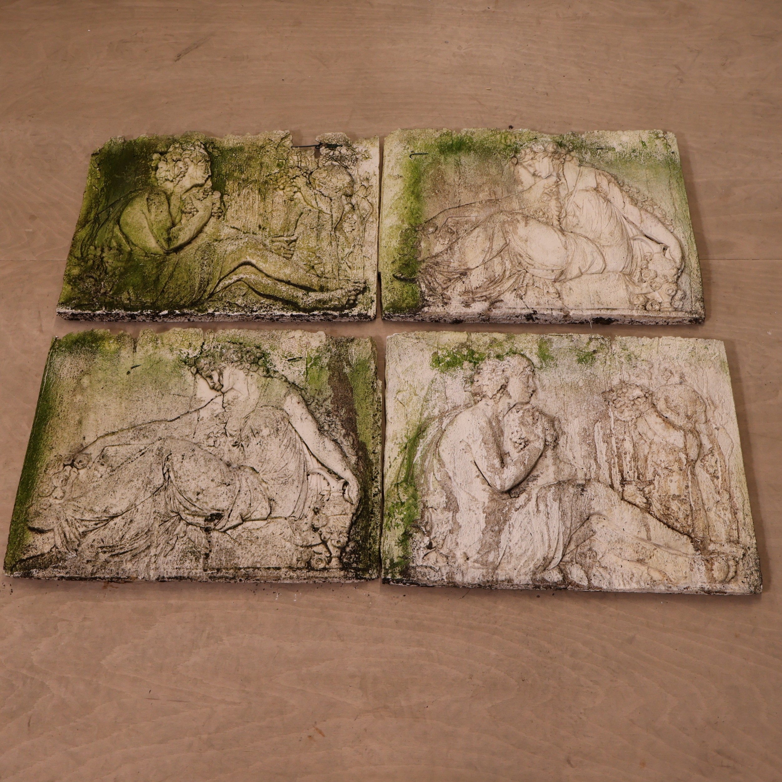 Four weathered moulded plaster wall plaques depicting classical female ...