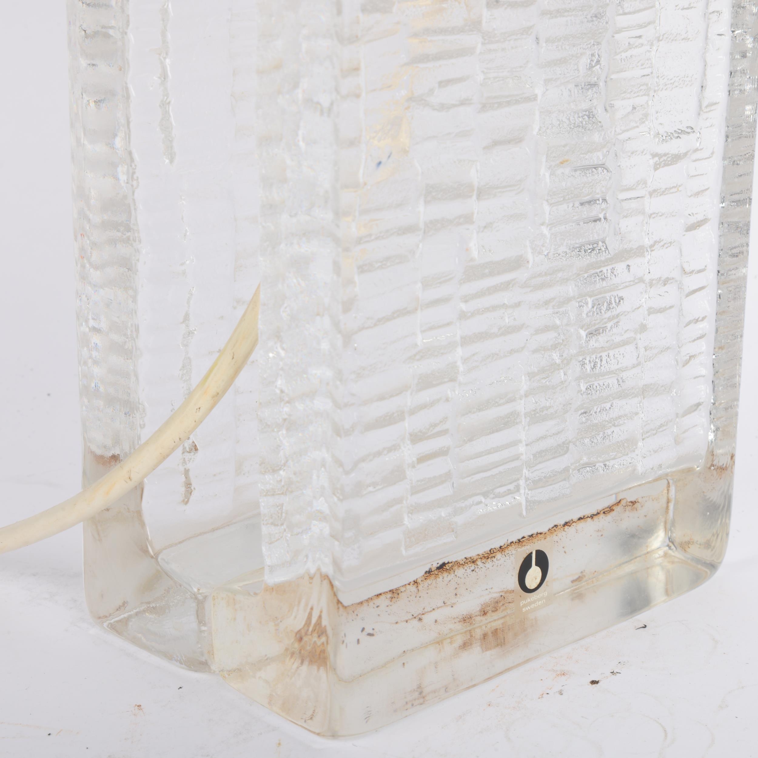 A mid century glass table lamp by Pukeberg, Sweden, jointed 