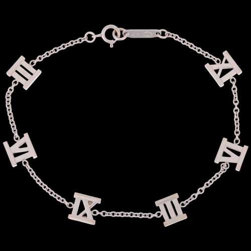 1104 - TIFFANY & CO - an 18ct white gold Atlas Collection chain bracelet, with Roman numeral stations, sign... 