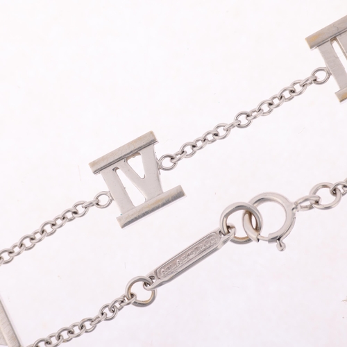 1104 - TIFFANY & CO - an 18ct white gold Atlas Collection chain bracelet, with Roman numeral stations, sign... 