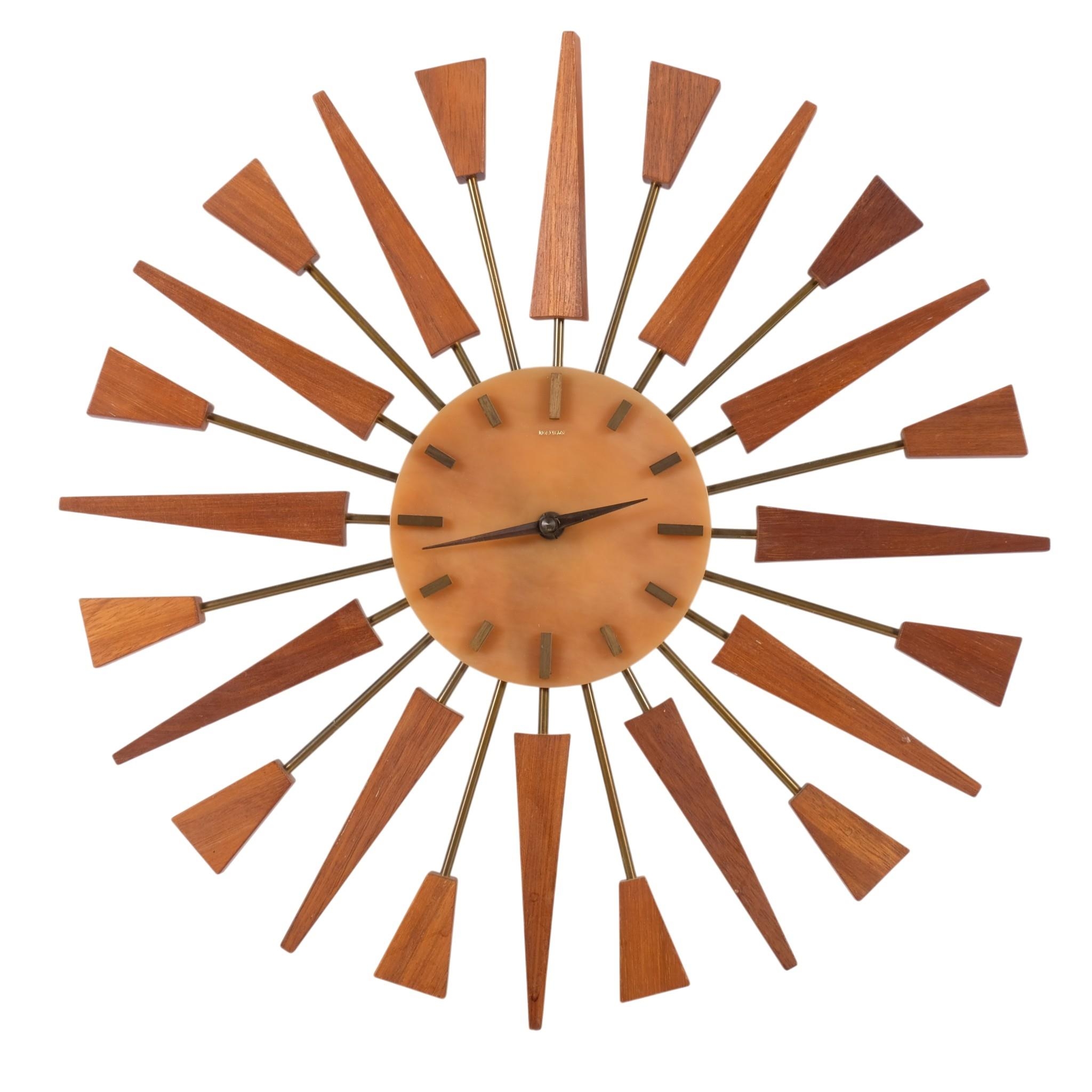 A mid-century starburst design wall clock, by Manley, with brass and ...