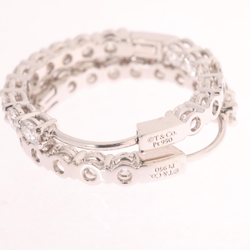 105 - TIFFANY & CO - a pair of platinum diamond hoop earrings, both set inside-out with modern round brill... 