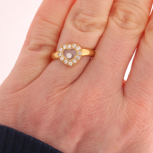 110 - CHOPARD - an 18ct gold 'Happy Diamonds' ring, the heart panel glazed and revealing a 'Floating' diam... 