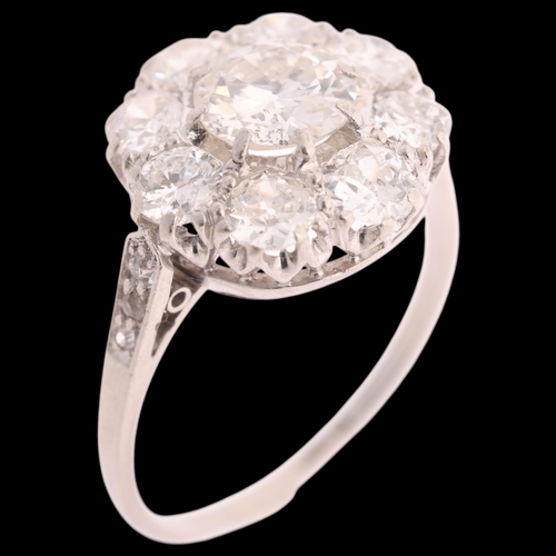 117 - A platinum diamond cluster ring, centrally claw set with 0.90ct round transitional-cut diamond, surr... 