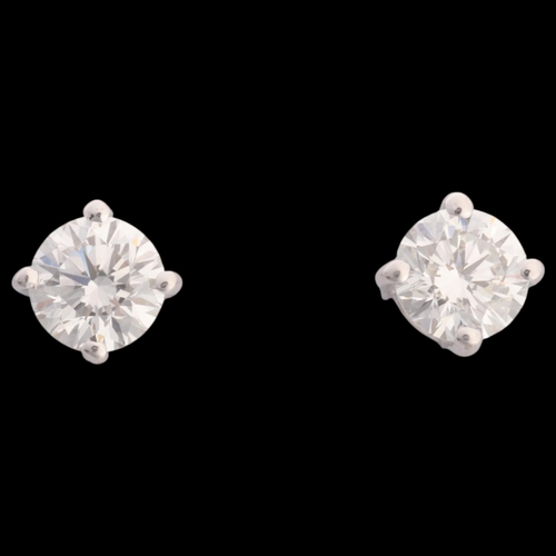 304 - A pair of 18ct white gold 0.80ct single stone diamond stud earrings, each claw set with 0.40ct moder... 
