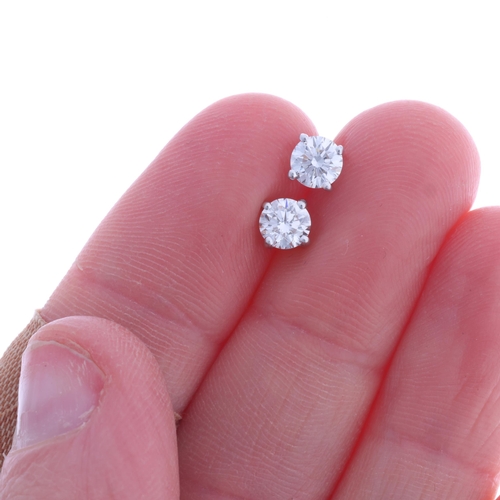 304 - A pair of 18ct white gold 0.80ct single stone diamond stud earrings, each claw set with 0.40ct moder... 