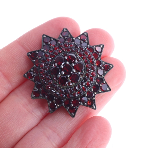 345 - An Antique Victorian Bohemian garnet flowerhead brooch, set with round flat top and rose-cut garnets... 