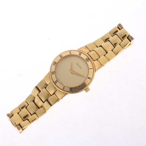 41 - GUCCI - a lady's gold plated quartz bracelet watch, ref. 3300.2.L, champagne dial with dauphine hand... 