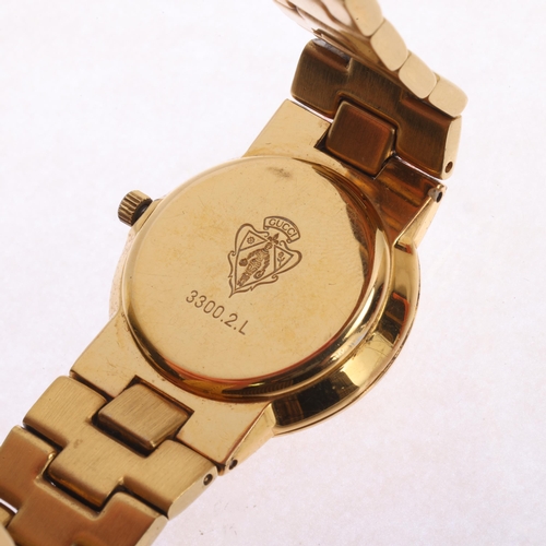 41 - GUCCI - a lady's gold plated quartz bracelet watch, ref. 3300.2.L, champagne dial with dauphine hand... 