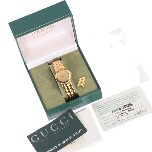 41 - GUCCI - a lady's gold plated quartz bracelet watch, ref. 3300.2.L, champagne dial with dauphine hand... 