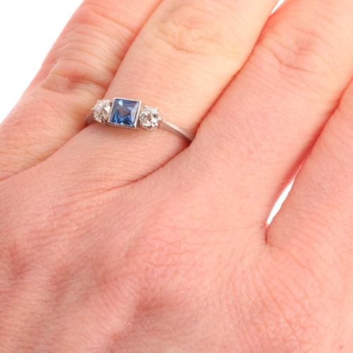 361 - A platinum three stone sapphire and diamond ring, millegrain set with 0.20ct square scissor-cut sapp... 