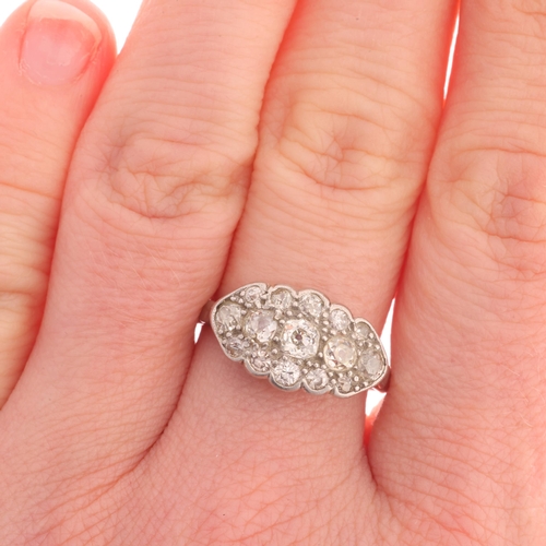 369 - An Antique platinum diamond boat cluster ring, millegrain set with old-cut diamonds, total diamond c... 