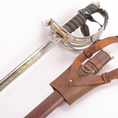 84 - A George VI Army Officer's dress sword, pierced steel basket hilt with shagreen grips, etched blade ... 