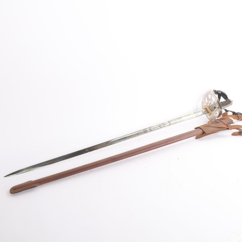 84 - A George VI Army Officer's dress sword, pierced steel basket hilt with shagreen grips, etched blade ... 