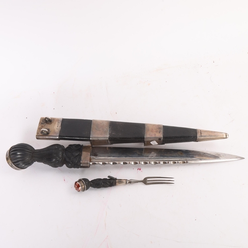 85 - A George V Scottish silver-mounted dirk, with ebonised basket-weave hilt, the pommel set with a cut-... 
