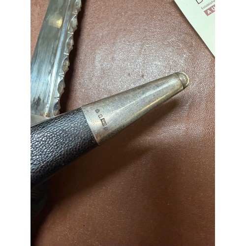 85 - A George V Scottish silver-mounted dirk, with ebonised basket-weave hilt, the pommel set with a cut-... 