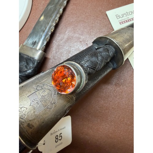 85 - A George V Scottish silver-mounted dirk, with ebonised basket-weave hilt, the pommel set with a cut-... 