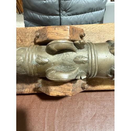 87 - A heavy solid cast-bronze model cannon, on rustic wood stand, barrel length 41cm