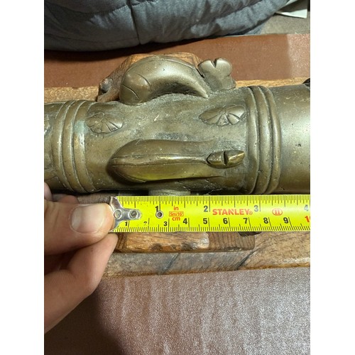 87 - A heavy solid cast-bronze model cannon, on rustic wood stand, barrel length 41cm