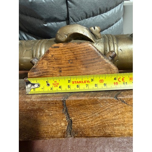 87 - A heavy solid cast-bronze model cannon, on rustic wood stand, barrel length 41cm