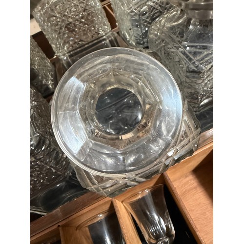 61 - A Victorian oak tantalus with 3 square cut-glass decanters, fold-out lids enclosing 3 liqueur glasse... 