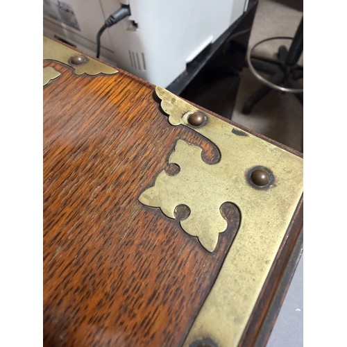 61 - A Victorian oak tantalus with 3 square cut-glass decanters, fold-out lids enclosing 3 liqueur glasse... 