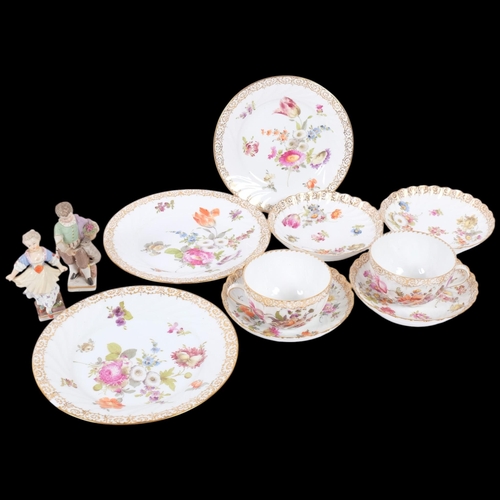 158 - A group of Dresden hand painted and gilded teaware, and a pair of Sitzendorf porcelain figures