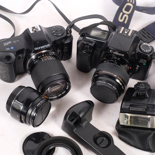 213 - A Canon EOS1000F 35mm camera, Olympus OM101 35mm camera, spare lenses and accessories