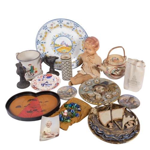 323 - A box of various ceramics, frog surprise mug, Vintage doll, etc.