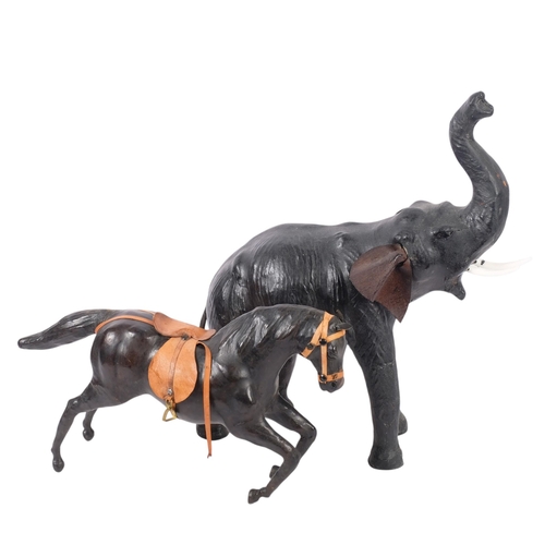 338 - A leather-covered Vintage elephant with trunk raised, H45cm, together with a similar leather-covered... 