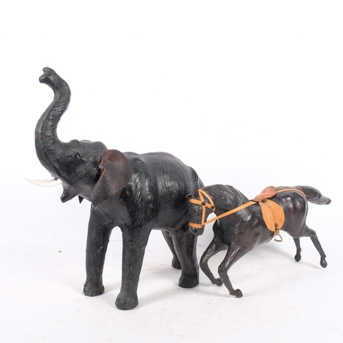 338 - A leather-covered Vintage elephant with trunk raised, H45cm, together with a similar leather-covered... 