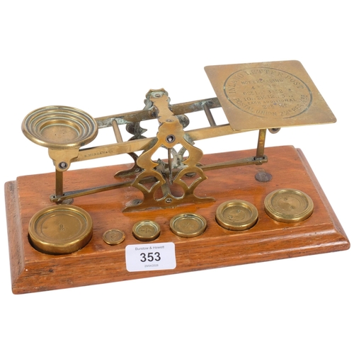 353 - A Victorian brass postal scales, on oak base, with a graduated set of weights, W26.5cm