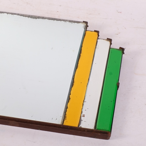 712 - An Art Deco mirror, with multi-coloured geometric panels surrounding rectangular central panel. Widt... 
