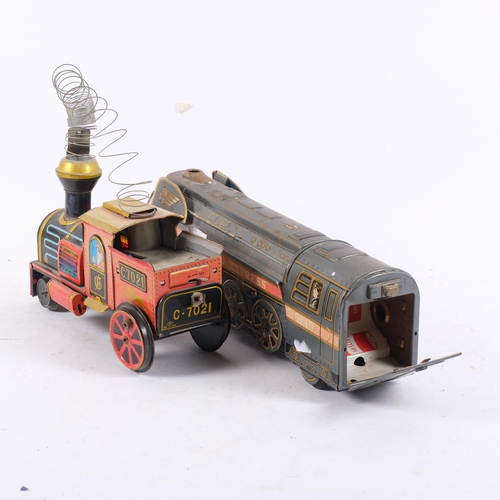 925 - A mid-20th century tinplate model locomotive, by Modern Toys, Japan, and another similar locomotive ... 